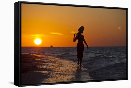 A Silhouette of a Woman Wearing a Hat Walking in the Surf at Sunset on Holbox Island, Mexico-Karine Aigner-Framed Stretched Canvas