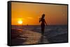 A Silhouette of a Woman Wearing a Hat Walking in the Surf at Sunset on Holbox Island, Mexico-Karine Aigner-Framed Stretched Canvas