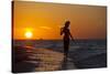 A Silhouette of a Woman Wearing a Hat Walking in the Surf at Sunset on Holbox Island, Mexico-Karine Aigner-Stretched Canvas