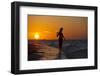 A Silhouette of a Woman Wearing a Hat Walking in the Surf at Sunset on Holbox Island, Mexico-Karine Aigner-Framed Photographic Print