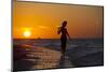 A Silhouette of a Woman Wearing a Hat Walking in the Surf at Sunset on Holbox Island, Mexico-Karine Aigner-Mounted Photographic Print