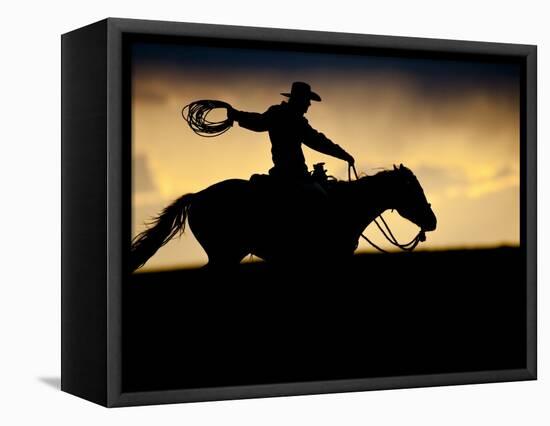 A Silhouetted Cowboy Riding Alone a Ridge at Sunset in Shell, Wyoming, USA-Joe Restuccia III-Framed Stretched Canvas