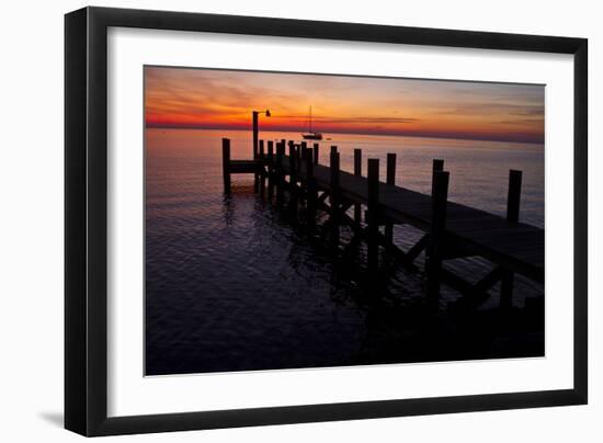 A Single Sailboat Sits on the Water of the Bay Alongside an Empty Dock on Tilghman Island, Maryland-Karine Aigner-Framed Photographic Print