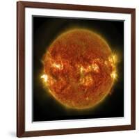 A Solar Flare Erupting on the Left Side of the Sun-null-Framed Art Print