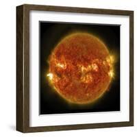 A Solar Flare Erupting on the Left Side of the Sun-null-Framed Art Print