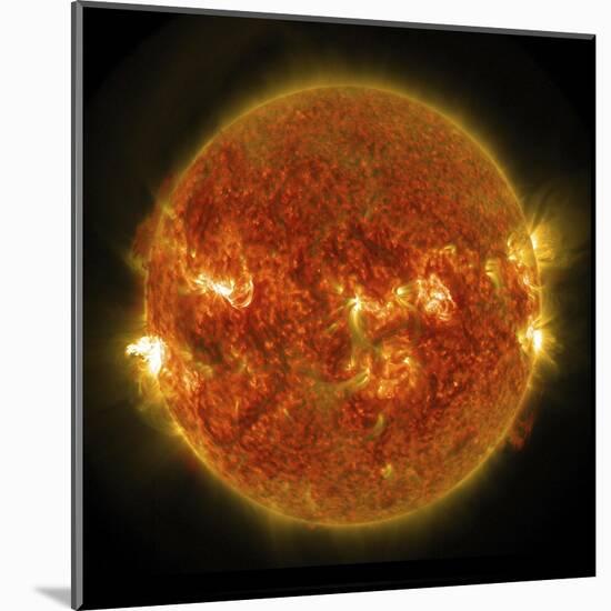 A Solar Flare Erupting on the Left Side of the Sun-null-Mounted Art Print