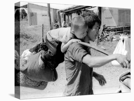 A South Vietnamese Father Carries His Son and a Bag of Household Possessions-null-Stretched Canvas