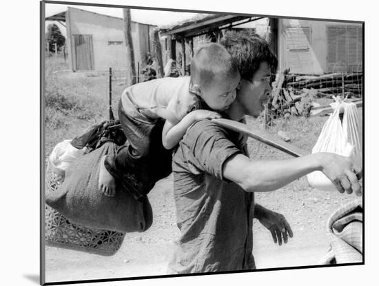 A South Vietnamese Father Carries His Son and a Bag of Household Possessions-null-Mounted Premium Photographic Print