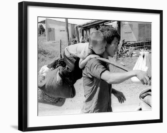 A South Vietnamese Father Carries His Son and a Bag of Household Possessions-null-Framed Photographic Print