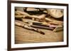 A Stained Brush, Colored Pencils of Different Colors, a Pair of Eyeglasses and an Old Clock on a Ta-nito-Framed Premium Photographic Print