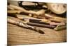 A Stained Brush, Colored Pencils of Different Colors, a Pair of Eyeglasses and an Old Clock on a Ta-nito-Mounted Premium Photographic Print