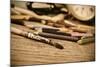 A Stained Brush, Colored Pencils of Different Colors, a Pair of Eyeglasses and an Old Clock on a Ta-nito-Mounted Photographic Print