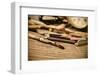 A Stained Brush, Colored Pencils of Different Colors, a Pair of Eyeglasses and an Old Clock on a Ta-nito-Framed Photographic Print