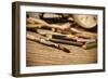 A Stained Brush, Colored Pencils of Different Colors, a Pair of Eyeglasses and an Old Clock on a Ta-nito-Framed Photographic Print