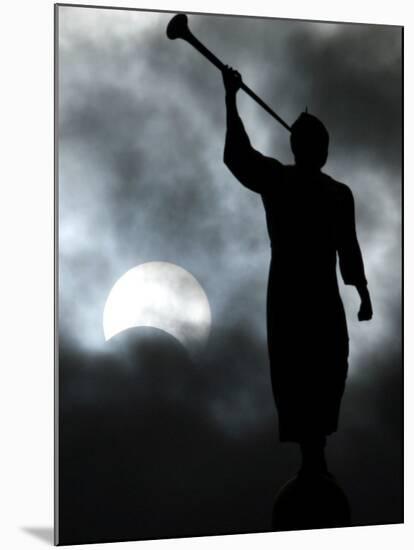 A Statue is Seen against a Cloudy Sky and a Partial Solar Eclipse-null-Mounted Premium Photographic Print