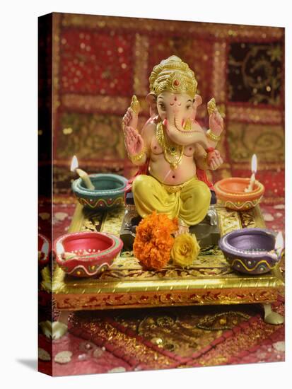 A Statue of a Mythological Elephant God -Ganesha, Surrounded by Traditional Divali Lamps-satel-Stretched Canvas