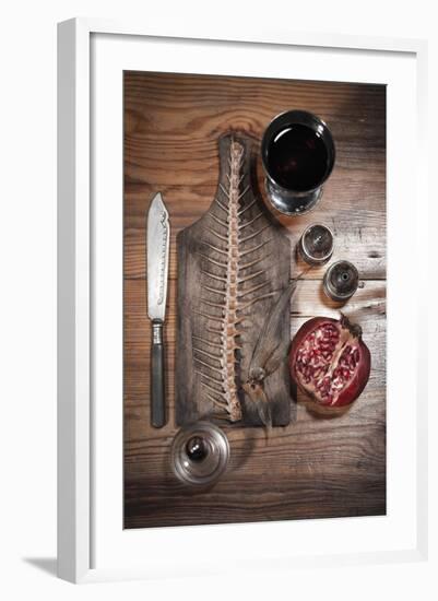 A Still Life Featuring a Fish Skeleton, Pomegranate and Red Wine-Komar-Framed Photographic Print