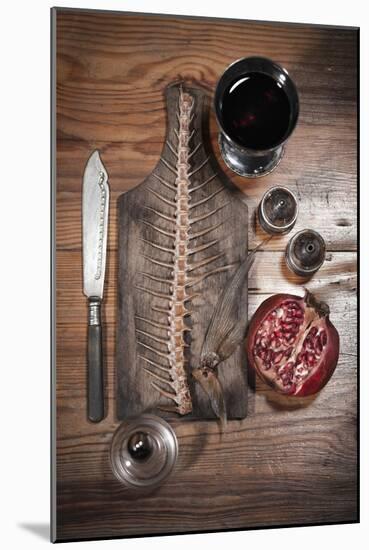 A Still Life Featuring a Fish Skeleton, Pomegranate and Red Wine-Komar-Mounted Photographic Print