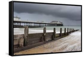 A stormy sky over the beach and pier at Cromer, Norfolk, England, United Kingdom, Europe-Jon Gibbs-Framed Stretched Canvas