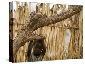 A Sudanese Girl Plays Inside a Thatched Hut at the Refugee Camp of Zamzam-null-Stretched Canvas
