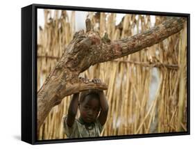 A Sudanese Girl Plays Inside a Thatched Hut at the Refugee Camp of Zamzam-null-Framed Stretched Canvas