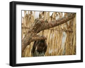 A Sudanese Girl Plays Inside a Thatched Hut at the Refugee Camp of Zamzam-null-Framed Photographic Print