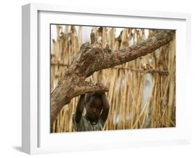 A Sudanese Girl Plays Inside a Thatched Hut at the Refugee Camp of Zamzam-null-Framed Photographic Print