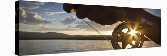 A Sunset Sunstart Through the Fly Reel of an Angler on the Henry's Fork River in Idaho.-Clint Losee-Stretched Canvas