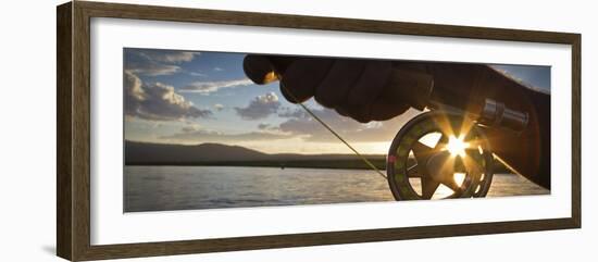 A Sunset Sunstart Through the Fly Reel of an Angler on the Henry's Fork River in Idaho.-Clint Losee-Framed Photographic Print