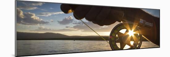 A Sunset Sunstart Through the Fly Reel of an Angler on the Henry's Fork River in Idaho.-Clint Losee-Mounted Photographic Print