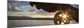 A Sunset Sunstart Through the Fly Reel of an Angler on the Henry's Fork River in Idaho.-Clint Losee-Mounted Photographic Print