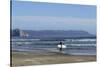 A surfer approaches the water, Morro Rock in the background. San Luis Obispo County, California, Us-Susan Pease-Stretched Canvas
