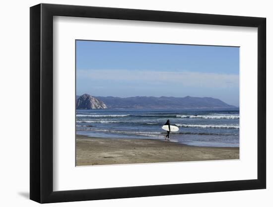 A surfer approaches the water, Morro Rock in the background. San Luis Obispo County, California, Us-Susan Pease-Framed Photographic Print