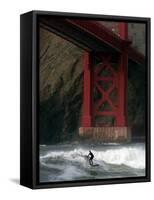 A Surfer is Dwarfed by the Northern End of the Golden Gate Bridge While Riding the Waves-null-Framed Stretched Canvas