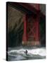 A Surfer is Dwarfed by the Northern End of the Golden Gate Bridge While Riding the Waves-null-Stretched Canvas