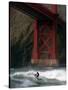 A Surfer is Dwarfed by the Northern End of the Golden Gate Bridge While Riding the Waves-null-Stretched Canvas
