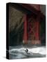 A Surfer is Dwarfed by the Northern End of the Golden Gate Bridge While Riding the Waves-null-Stretched Canvas