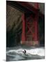 A Surfer is Dwarfed by the Northern End of the Golden Gate Bridge While Riding the Waves-null-Mounted Photographic Print