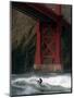 A Surfer is Dwarfed by the Northern End of the Golden Gate Bridge While Riding the Waves-null-Mounted Photographic Print