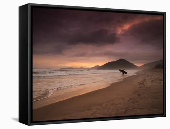 A Surfer Makes His Way Out of the Water at Praia Itamambuca in Ubatuba, Brazil-Alex Saberi-Framed Stretched Canvas