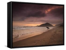 A Surfer Makes His Way Out of the Water at Praia Itamambuca in Ubatuba, Brazil-Alex Saberi-Framed Stretched Canvas