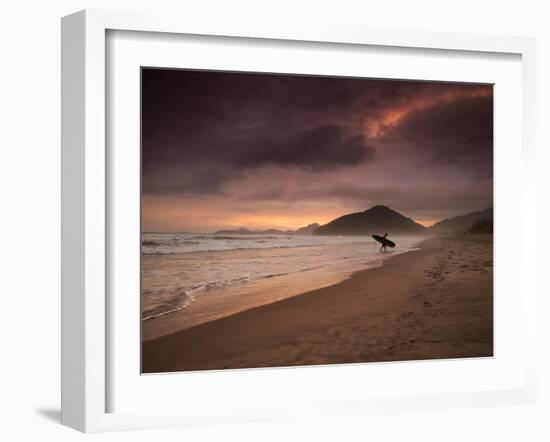 A Surfer Makes His Way Out of the Water at Praia Itamambuca in Ubatuba, Brazil-Alex Saberi-Framed Photographic Print