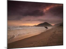 A Surfer Makes His Way Out of the Water at Praia Itamambuca in Ubatuba, Brazil-Alex Saberi-Mounted Photographic Print