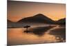 A Surfer Makes His Way Out of the Water at Sunset on Praia Do Itamambuca in Brazil-Alex Saberi-Mounted Photographic Print