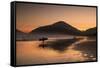 A Surfer Makes His Way Out of the Water at Sunset on Praia Do Itamambuca in Brazil-Alex Saberi-Framed Stretched Canvas