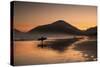 A Surfer Makes His Way Out of the Water at Sunset on Praia Do Itamambuca in Brazil-Alex Saberi-Stretched Canvas