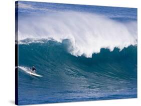 A Surfer Rides a Wave at Waimea Beach-null-Stretched Canvas