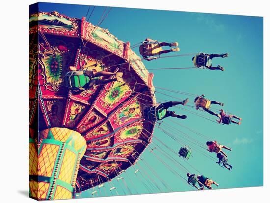 A Swinging Fair Ride at Dusk Toned with a Retro Vintage Instagram Filter App or Action-Annette Shaff-Stretched Canvas