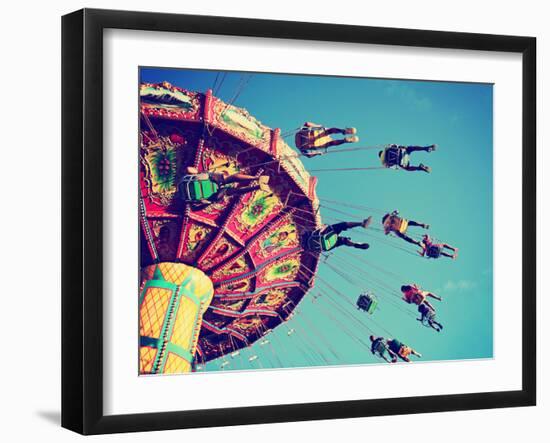 A Swinging Fair Ride at Dusk Toned with a Retro Vintage Instagram Filter App or Action-Annette Shaff-Framed Photographic Print