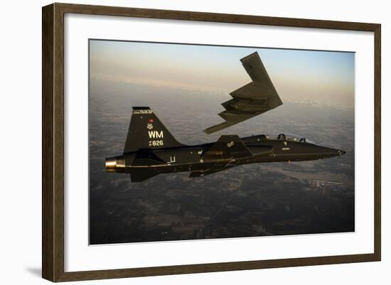 A T-38 Talon Flies in Formation with a B-2 Spirit-null-Framed Photographic Print